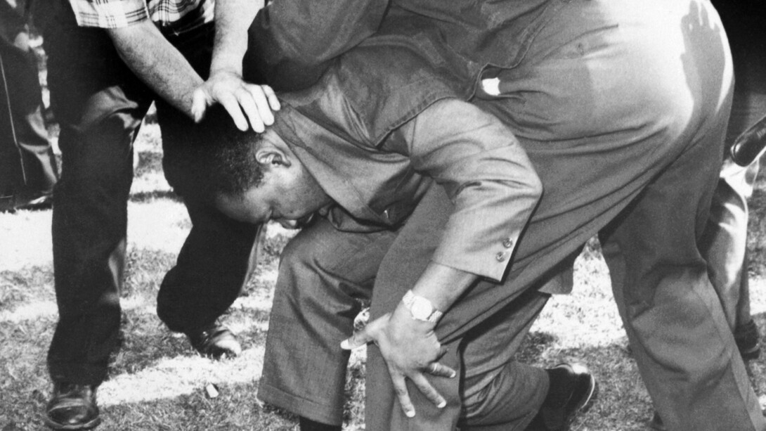 Martin Luther King Jr. was hit in the head with a brick and fell to one knee while attempting to hold a peaceful march, the Chicago Freedom March in Illinois, USA in 1966