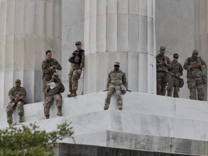 Eight US Army soldiers stand around the US Capital in Washington DC, USA