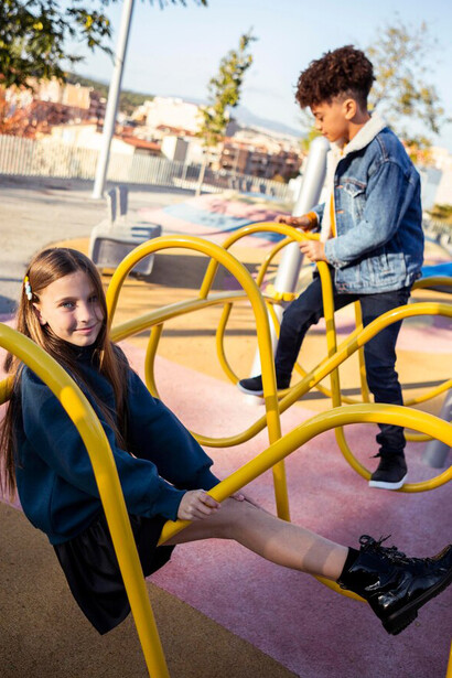Friends laughing and playing together at the playground