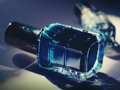 Nail polish bottle on a surface symbolize consumer behavior driven by emotional comfort, mood boosts, and trends in cosmetic sales
