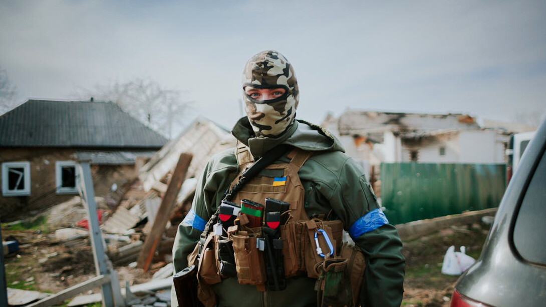 A solemn Ukrainian soldier gazes at the camera, embodying the steadfast resolve in defending homeland amidst turmoil