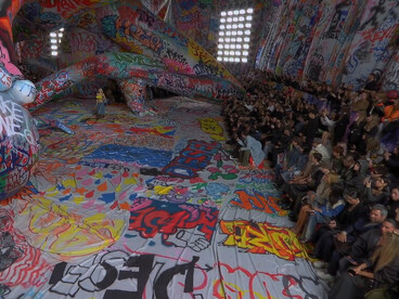 For the Diesel FW25 runway show, giant inflatables made from an expansive 3km canvas of street art create a powerful backdrop. The installation, born from an open call, showcases graffiti artists from India, Italy, South Africa, China, Japan, the United States, the United Arab Emirates, and Saudi Arabia