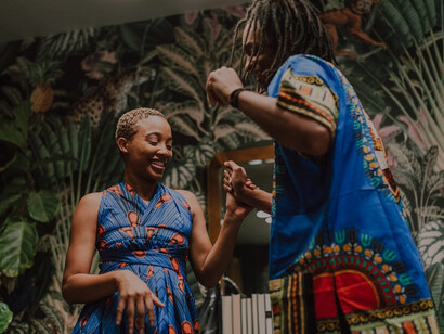 A woman gracefully dancing with a man in a coordinating blue shirt