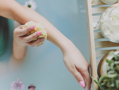 A woman luxuriates in a soothing bathtub, embracing self-love and indulging in a moment of relaxation on Galentine's Day