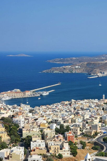 A scenic overlook of Ermoupoli, Syros, with the tranquil Aegean in the background, symbolizing why the island is celebrated as the cultural heart of the Cyclades