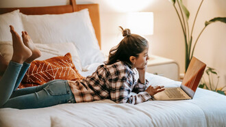 Lost in thought, she smiles at her laptop, cherishing the comforting conversations that once filled her day with warmth and laughter