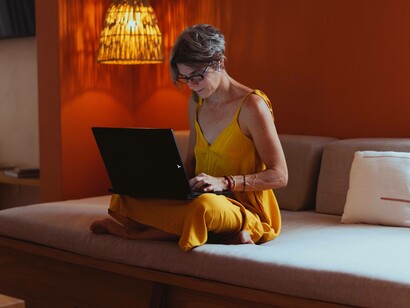A woman on her laptop competing in a world that carries the philosophy of "every man for himself"
