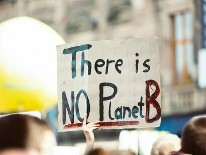 A raised sign boldly declares "There is NO Planet B," underscoring the urgency of addressing global climate change