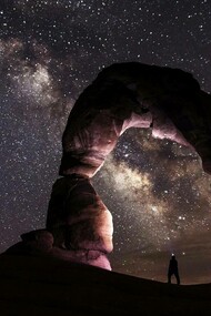 A man observes the galaxy and reflects on his own insigificance