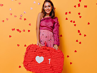 A woman joyfully displaying a thumbs-up decoration, radiating positivity