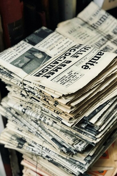 In a low-trust society, piles of newspapers may symbolize the overwhelming flow of information, where democracy and trust are undermined, leading to reduced civic participation