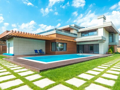 A residence layered with wood, glass and clean architectural lines, reflecting the softer, more inviting character of warm modern design