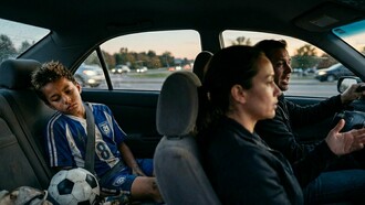 A child processing a painful loss in the back seat, representing the moments when parental support matters most