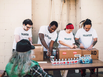 Water and food is shared with those in need by volunteers