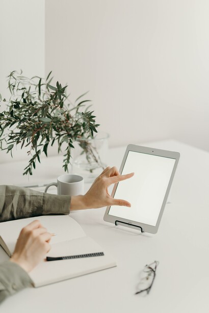 Person with a tablet and notebook