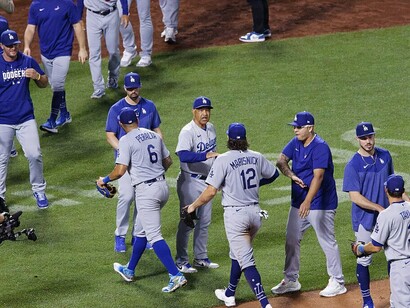 The Los Angeles Dodgers players celebrate a well-deserved victory after a 2023 game, which reflects their dedication and hard work 