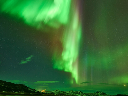 A spectacular display of the northern lights over Reykjahlíð in Þingeyjarsveit, Iceland