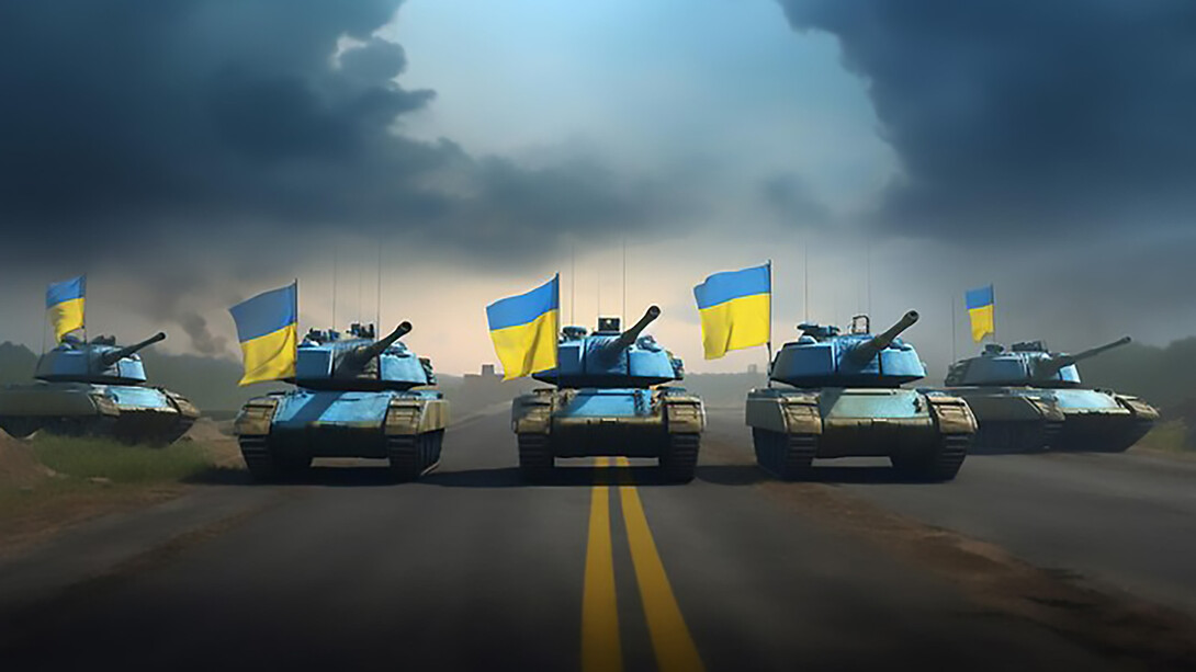 Modern tanks goes down a road flying the flag of Ukraine