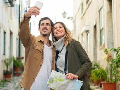 A couple walking through the city while looking at a map, Lisbon, Portugal