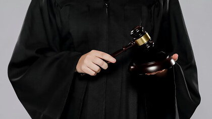 A female judge with gavel, symbolizing authority and justice