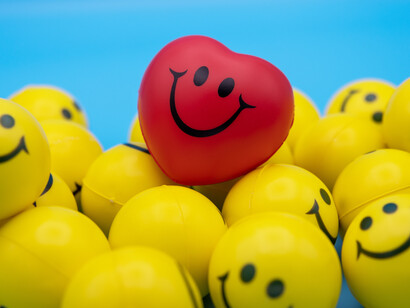 Yellow and red balls with smiley faces signifying happiness