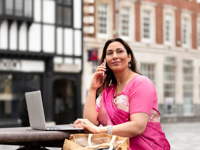 Focused on her computer, an Indian woman represents the drive for progress and empowerment in today's digital landscape