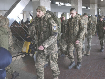 Ukrainian soldiers walk at Kyiv central train station, Ukraine, February 25, 2022, credit: Ümit Bektaş, Reuters