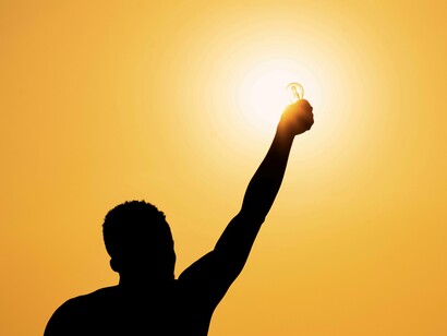 A former slave breaking away from the chains and raising his arm to the sun