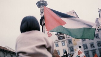 Lisbon, Portugal a child holding a Palestinian flag during a protest