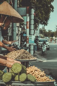 Woman selling peanuts at the side of the road