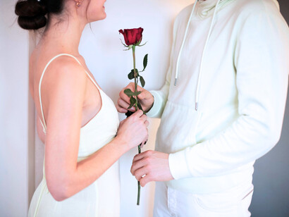 A couple holding a rose and sharing a precious moment, a visual metaphor for how sincerity in love now feels both rare and radical