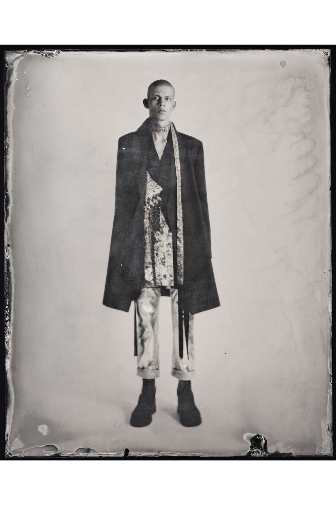 Kasia Wozniak, Wet Plate Collodion Ambrotype, Inspiration from the pages of Sherlock Holmes:
“… with a pea-jacket, and a coarse red scarf around his neck.” [The Sign of the Four by Arthur Conan Doyle] “He had a coloured scarf round his chin …” [The Sign of the Four by Arthur Conan Doyle], Fashion credits: Top and scarf: Ed Lee, BA Menswear, Central Saint Martins, 2014; Coat: Maison Martin Margiela; Jeans: Levi’s customised by stylist; Boots: Dr. Martens, © Kasia Wozniak/Museum of London