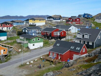 Casas de diferentes cores ocupam o terreno rochoso de Nuuk, na costa da Groenlândia. A paisagem urbana revela como as comunidades humanas se adaptaram a um dos ambientes mais extremos do planeta