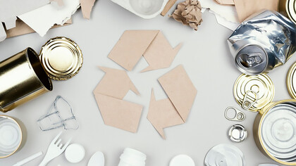 Flat lay of colorful recycling bins filled with paper, plastic, and glass waste, promoting eco-friendly practices and sustainable living