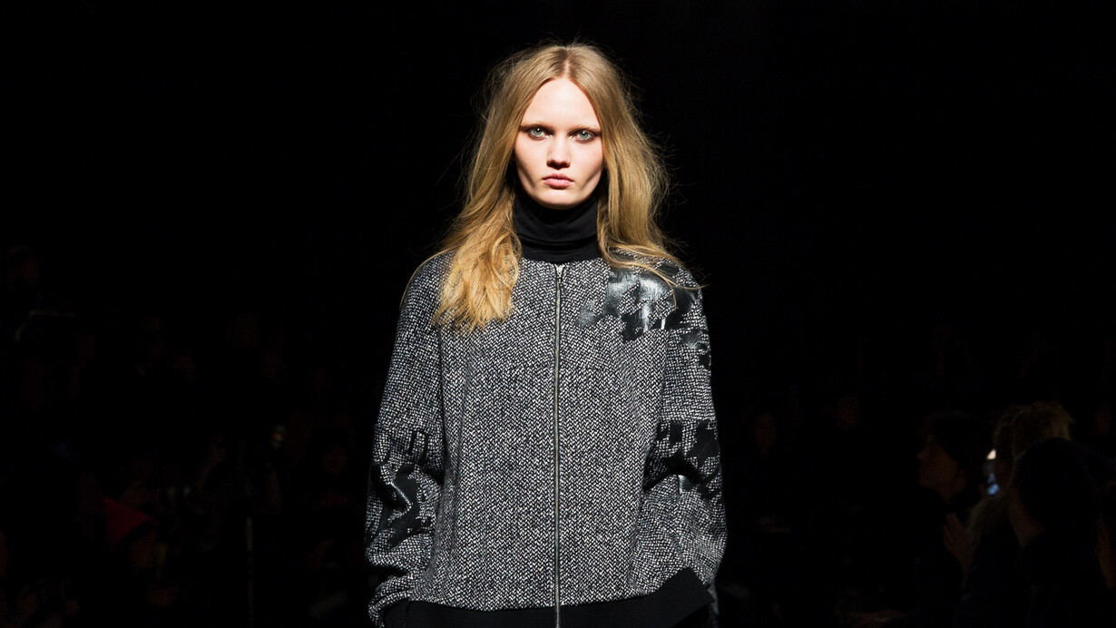 Intense and focused, this model's stare mirrors the fashion industry's urgent shift towards climate resilience and sustainable practices in 2024