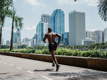 A man jogging along a city path, representing the importance of regular movement in lowering blood pressure naturally