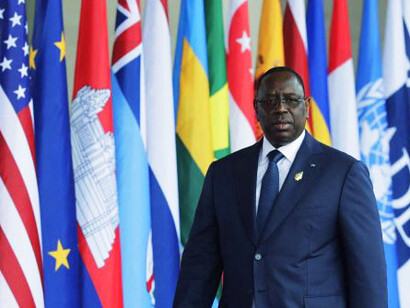 In a moment of reflection, former Senegalese President Macky Sall represents the ongoing struggle to reconcile African identity with the structural challenges created by Western influence and internal corruption