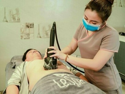 A patient undergoing a contemporary body sculpting treatment, reflecting advances in non-surgical aesthetic technology
