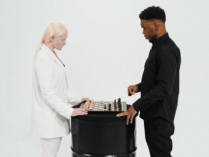 Two players considering their next move over a chessboard, symbolising the analytical reasoning needed to distinguish evidence from misinformation