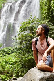 Surrounded by nature, he practices mindfulness, focusing on the present moment to clear his mind and reduce stress
