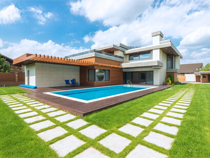 A home with warm wood with structured glass façades and open outdoor spaces, symbolising a more human-centred approach to modern residential design