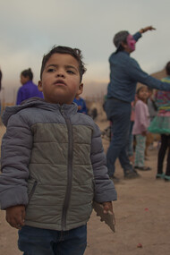 Children's Day celebration at La Mula land occupation. A child looks at the horizon, Chile