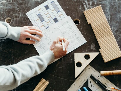 Engineers reviewing architectural blueprints and technical drawings, representing the careful planning that underpins long-term national development