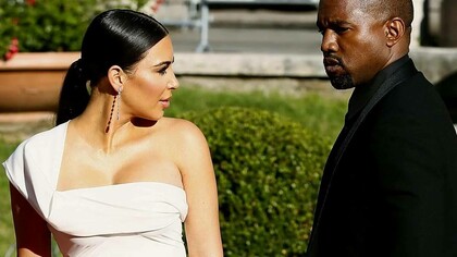 Kim Kardashian and Kanye West in a garden having a minor disagreement