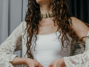 A peaceful woman meditates at home in a quiet indoor space, reflecting a mindful and calming morning ritual
