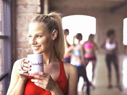 A woman enjoying a healthy drink after her workout