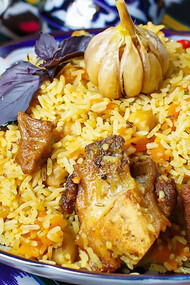 A plate of rice with meat and vegetables