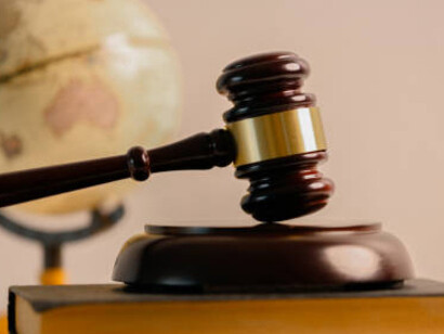 Law and justice illustrated with court symbols, legal books, and a globe to reflect global legal principles