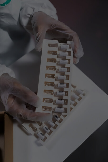 Amidst a backdrop of anticipation, a healthcare worker meticulously unwraps packages containing essential vaccines, poised to take part in the crucial process of vaccine distribution