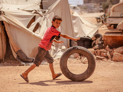 In the face of a world struggling with conflicts and inequality, children’s playtime in a refugee camp in Syria symbolises a resilient hope for a better future
